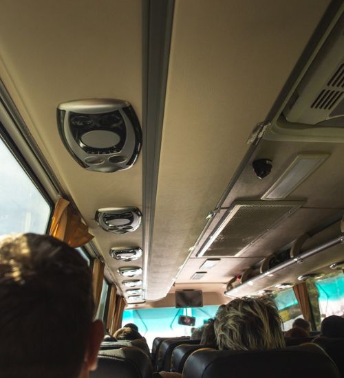 Charter bus interior amenities with air conditioning and overhead storage